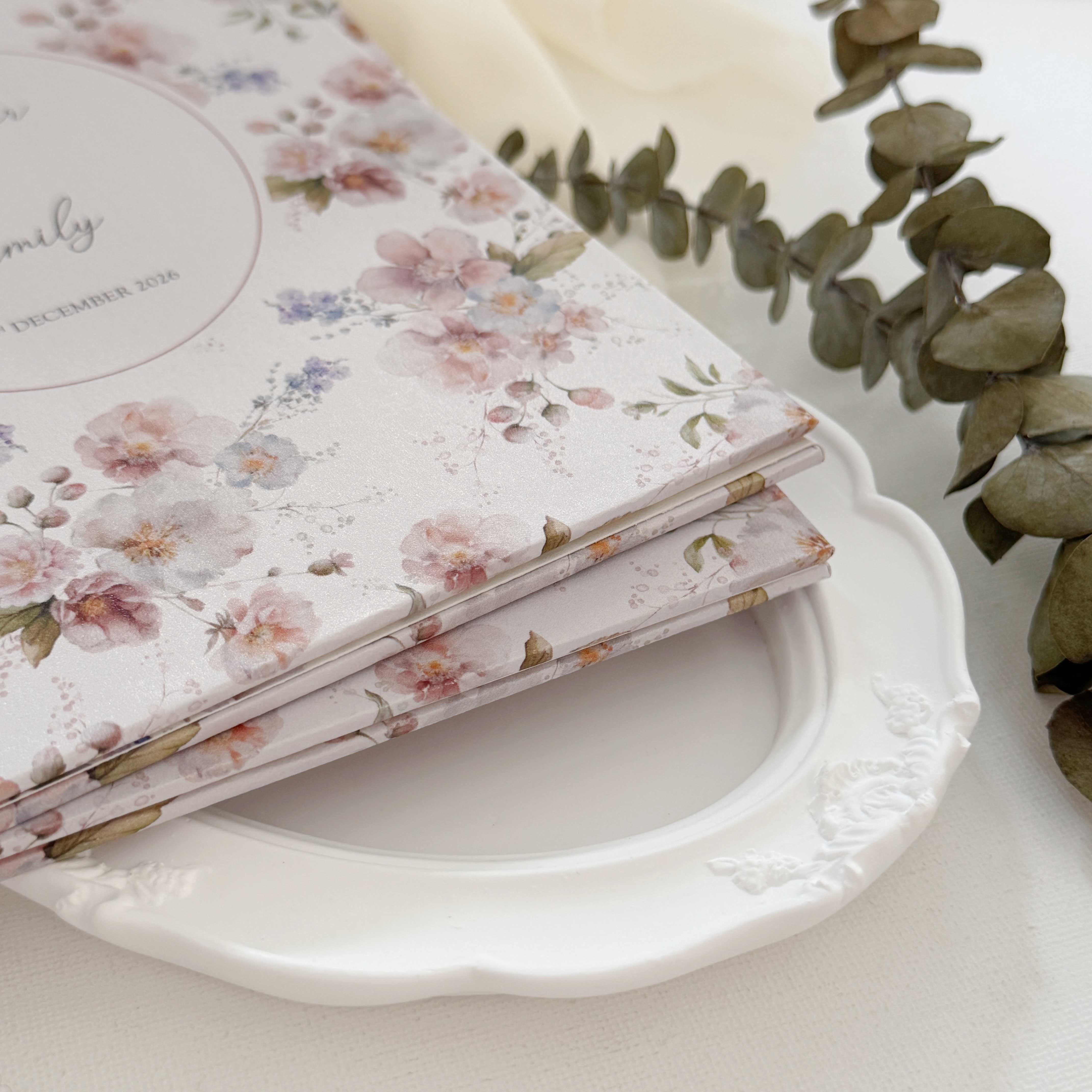 Hardcover wedding invitations offer a premium, book-like luxury presentation that makes a lasting statement for high-end ceremonies. Built on durable rigid chipboard, these invitations are often paired with high-end textures like matte laminate, velvet, or suede, and are finished with elegant hot foil stamping.