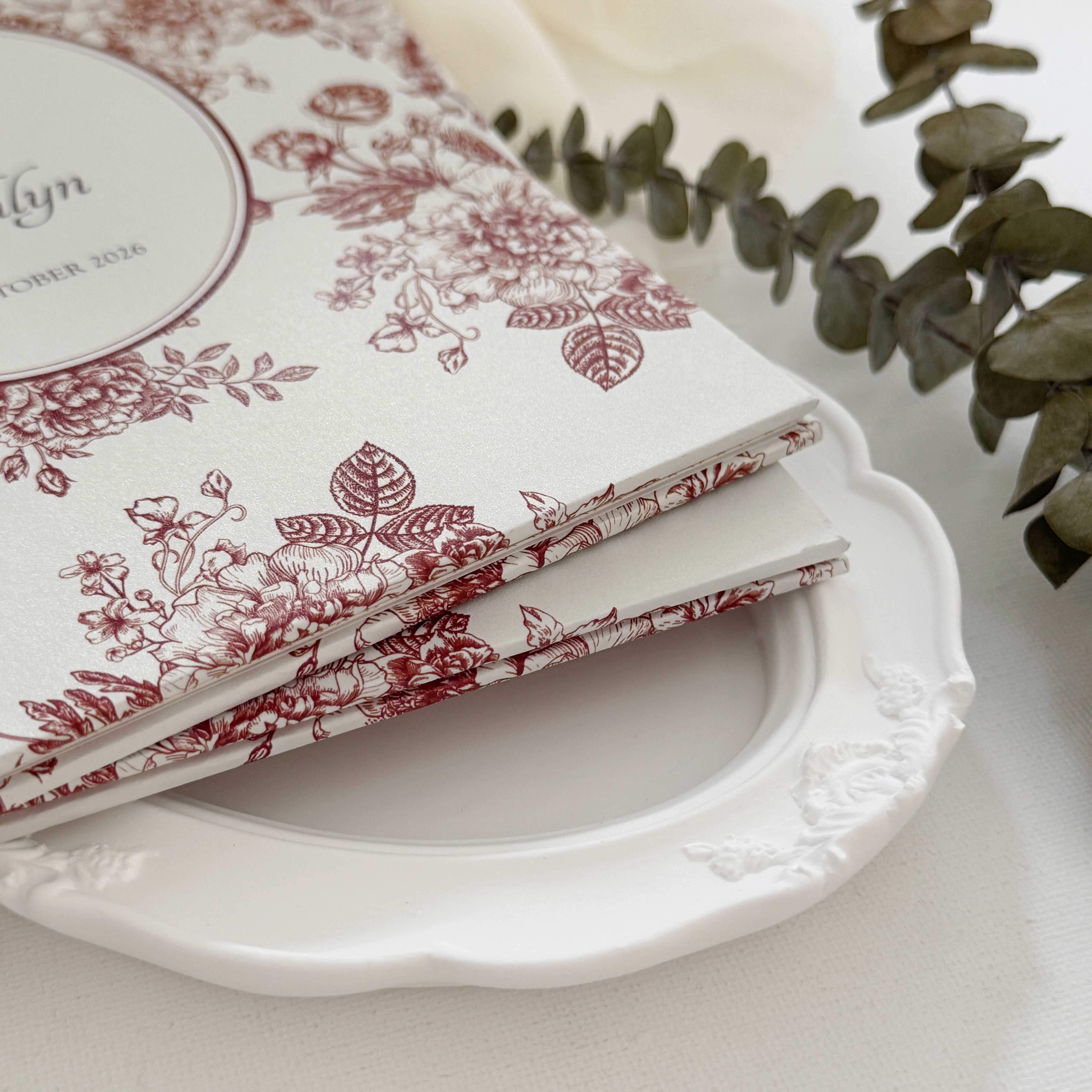 Hardcover wedding invitations offer a premium, book-like luxury presentation that makes a lasting statement for high-end ceremonies. Built on durable rigid chipboard, these invitations are often paired with high-end textures like matte laminate, velvet, or suede, and are finished with elegant hot foil stamping.