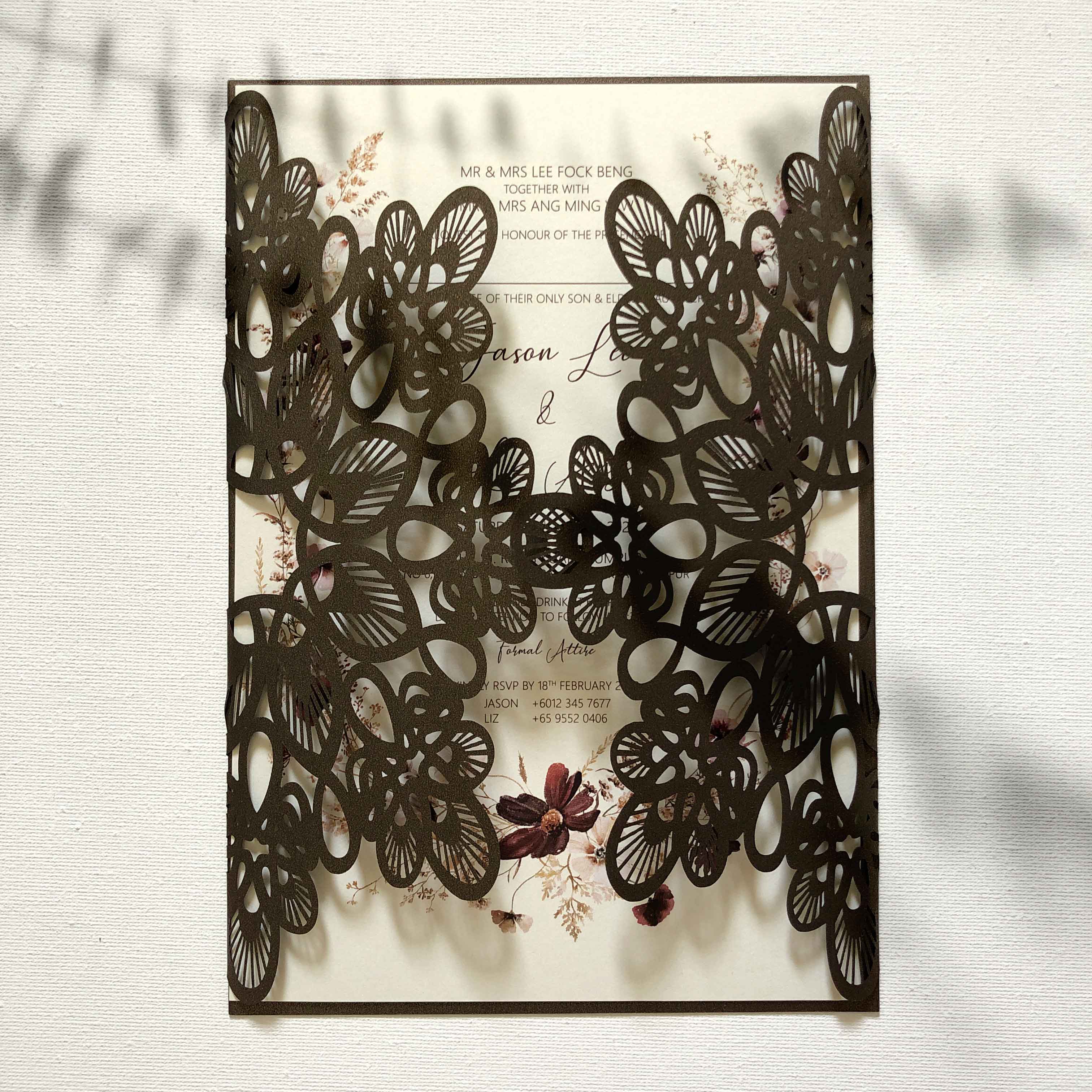 Decorative wedding invitation with butterfly cutout design on a textured white background