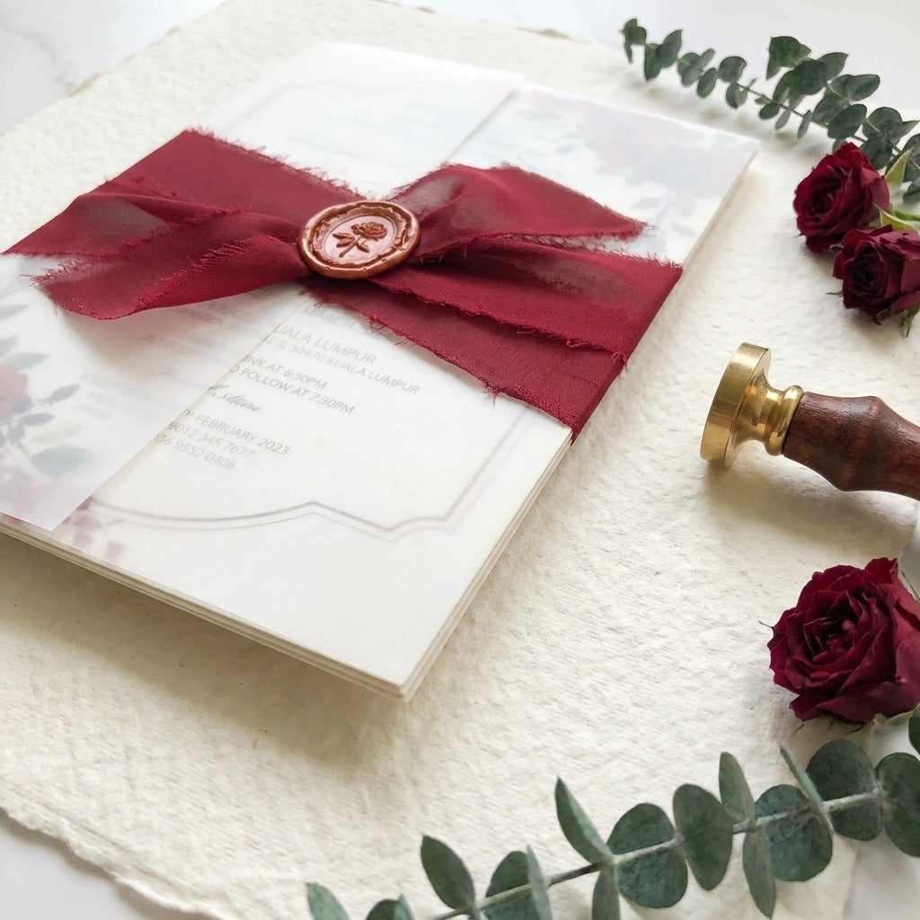 A chiffon ribbon wedding invitation provides a soft, ethereal, and organic aesthetic that perfectly complements elegant, fine-art, or bohemian wedding styles. Hand-frayed chiffon ribbons feature raw edges that add rich texture and motion to a stationary suite.