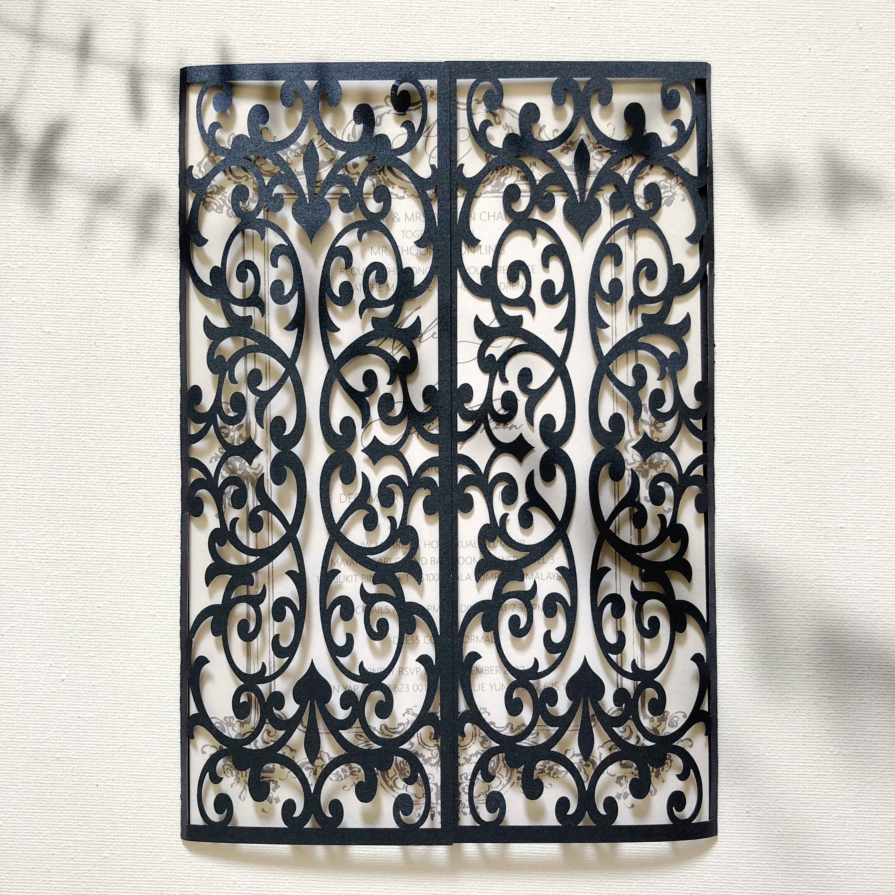 Decorative metal grille with intricate black pattern on a light background