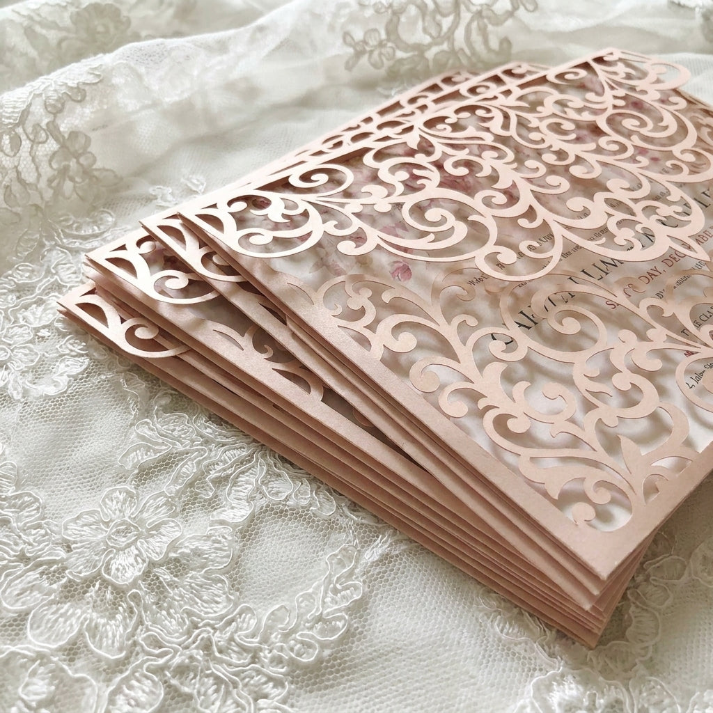 Stack of pink laser-cut cards on a lace background